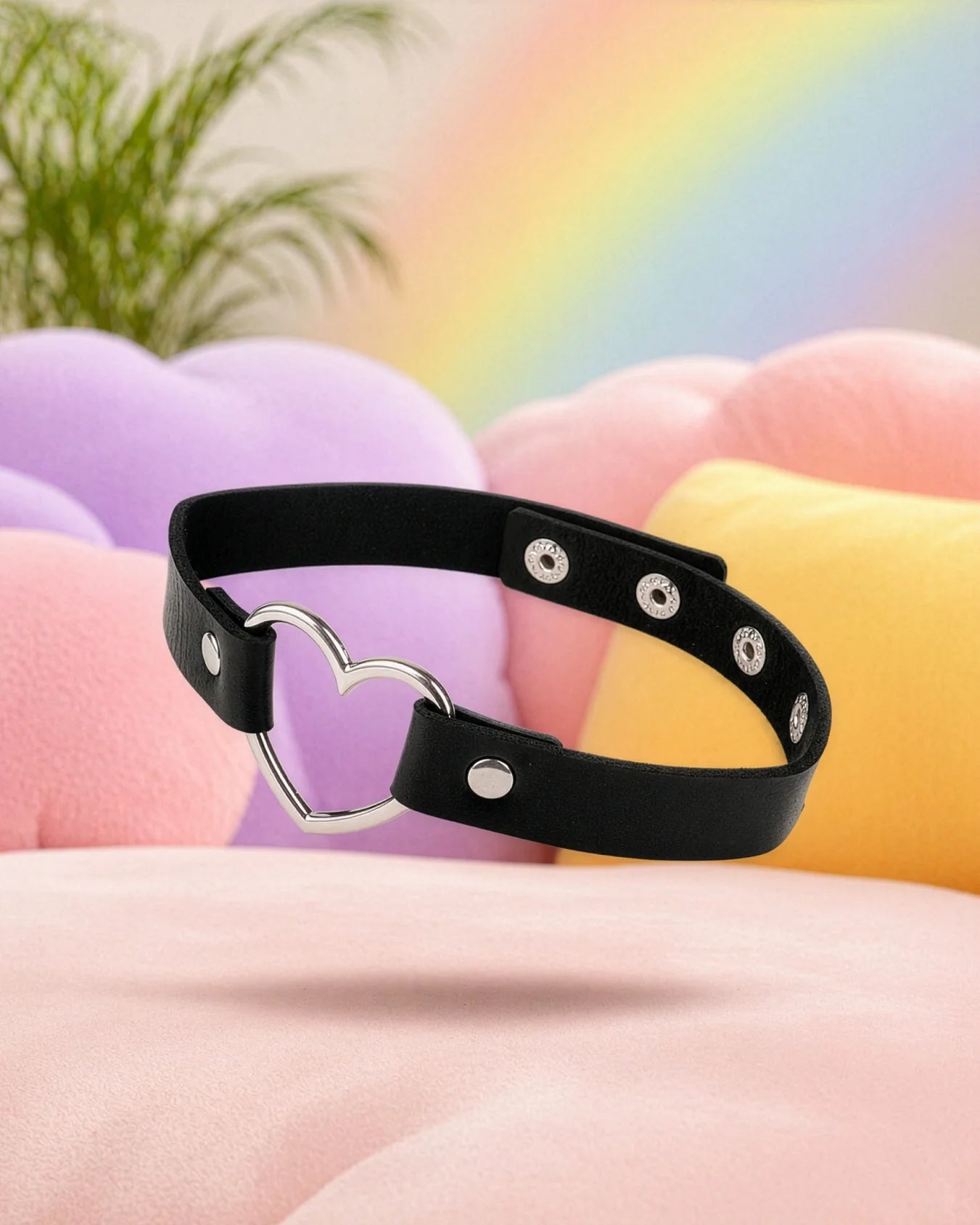Black faux leather heart choker collar floating in pastel bedroom, classic BDSM collar with adjustable fit and metal heart ring