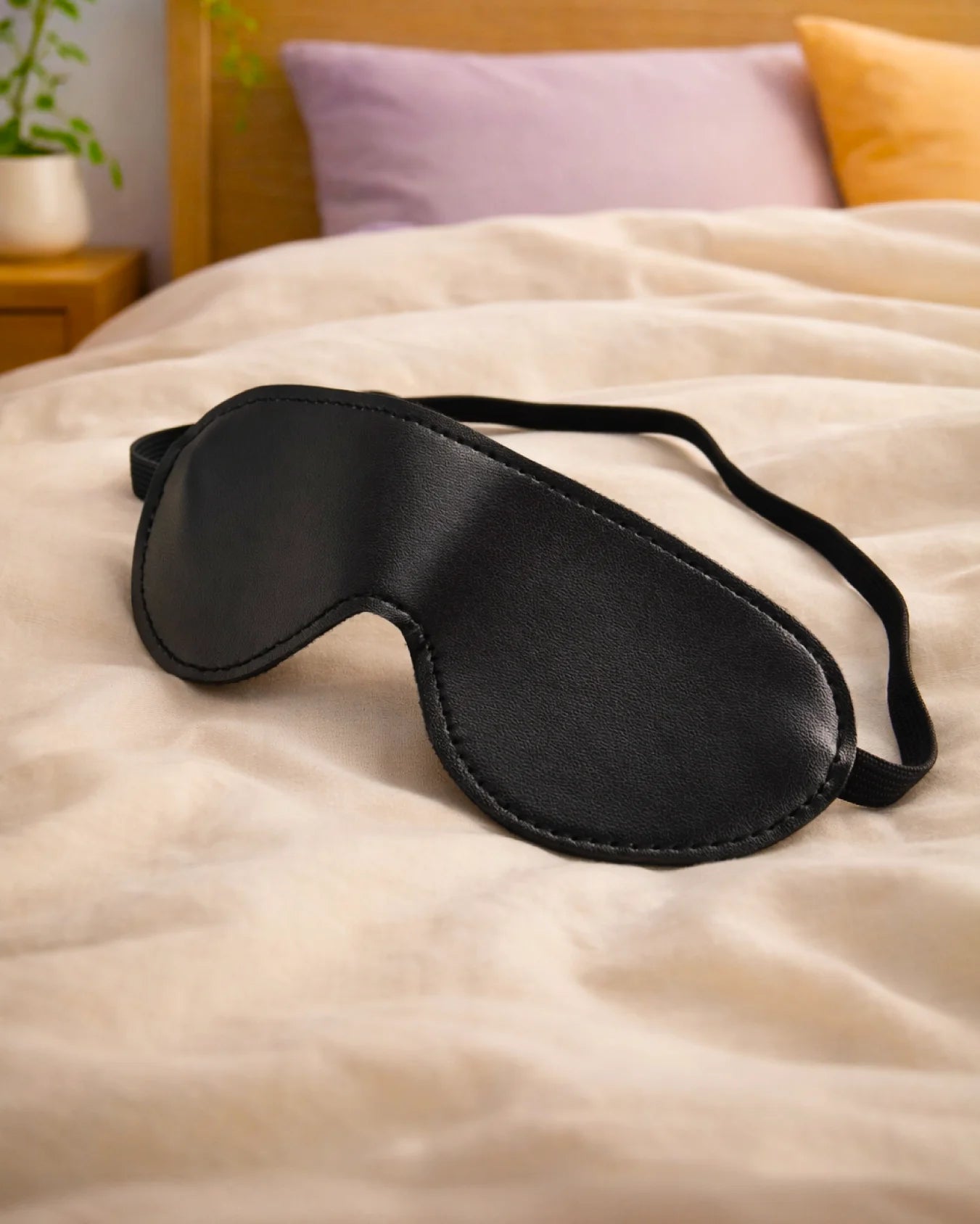Empower Play™ black faux leather beginner BDSM blindfold flat lay — classic design for sensory play