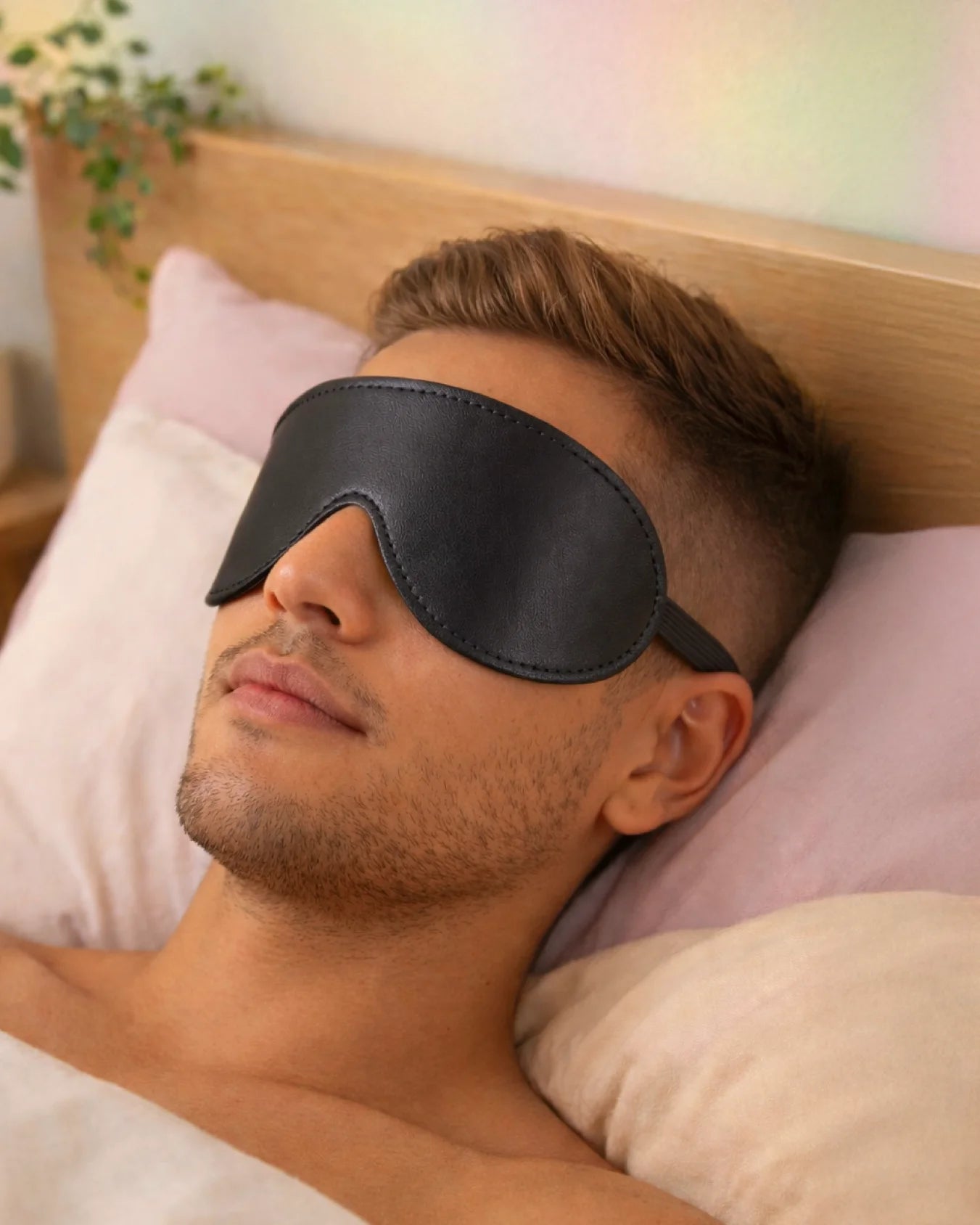 Man wearing Empower Play™ black BDSM blindfold for sensory play — comfortable beginner-friendly fit
