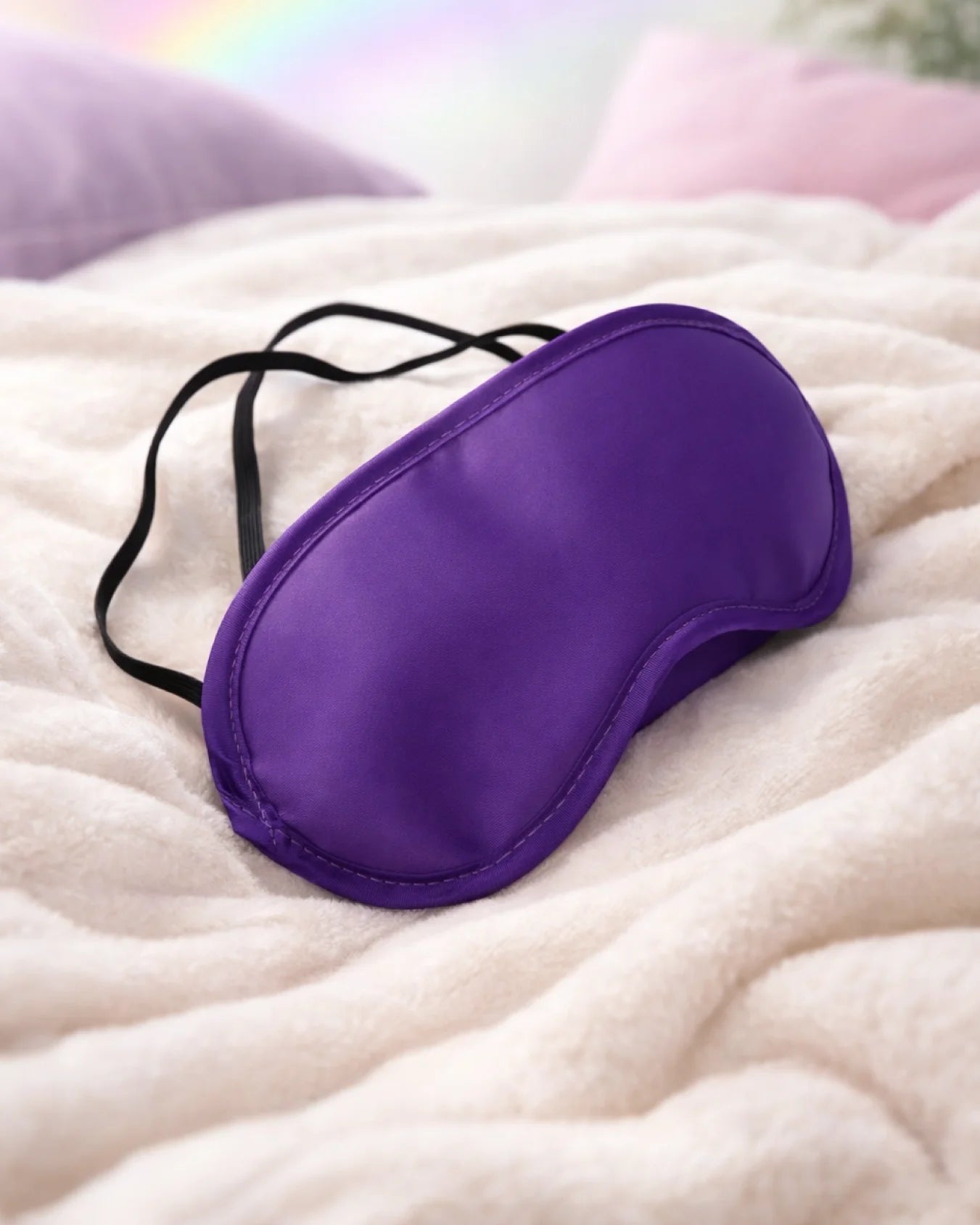 Purple satin blindfold resting on bed designed for beginner sensory play and smooth fabric comfort