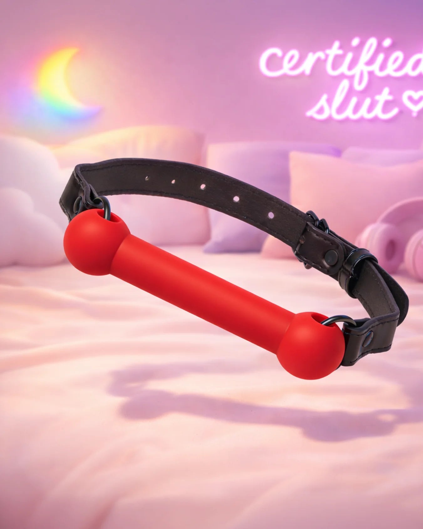 Red silicone bit gag by Empower Play™ floating in soft bedroom lighting, bold beginner-friendly mouth restraint
