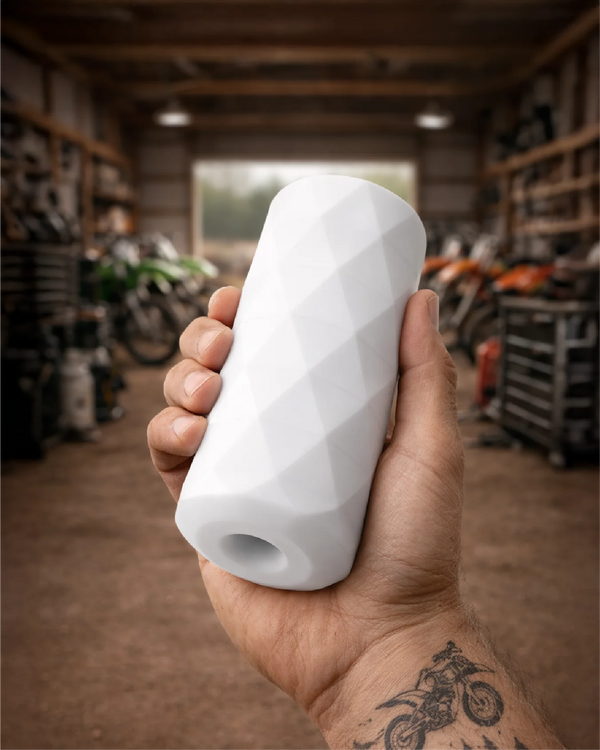 Iron Grip male stroker held in hand showing ultra-tight fit and compact size scale