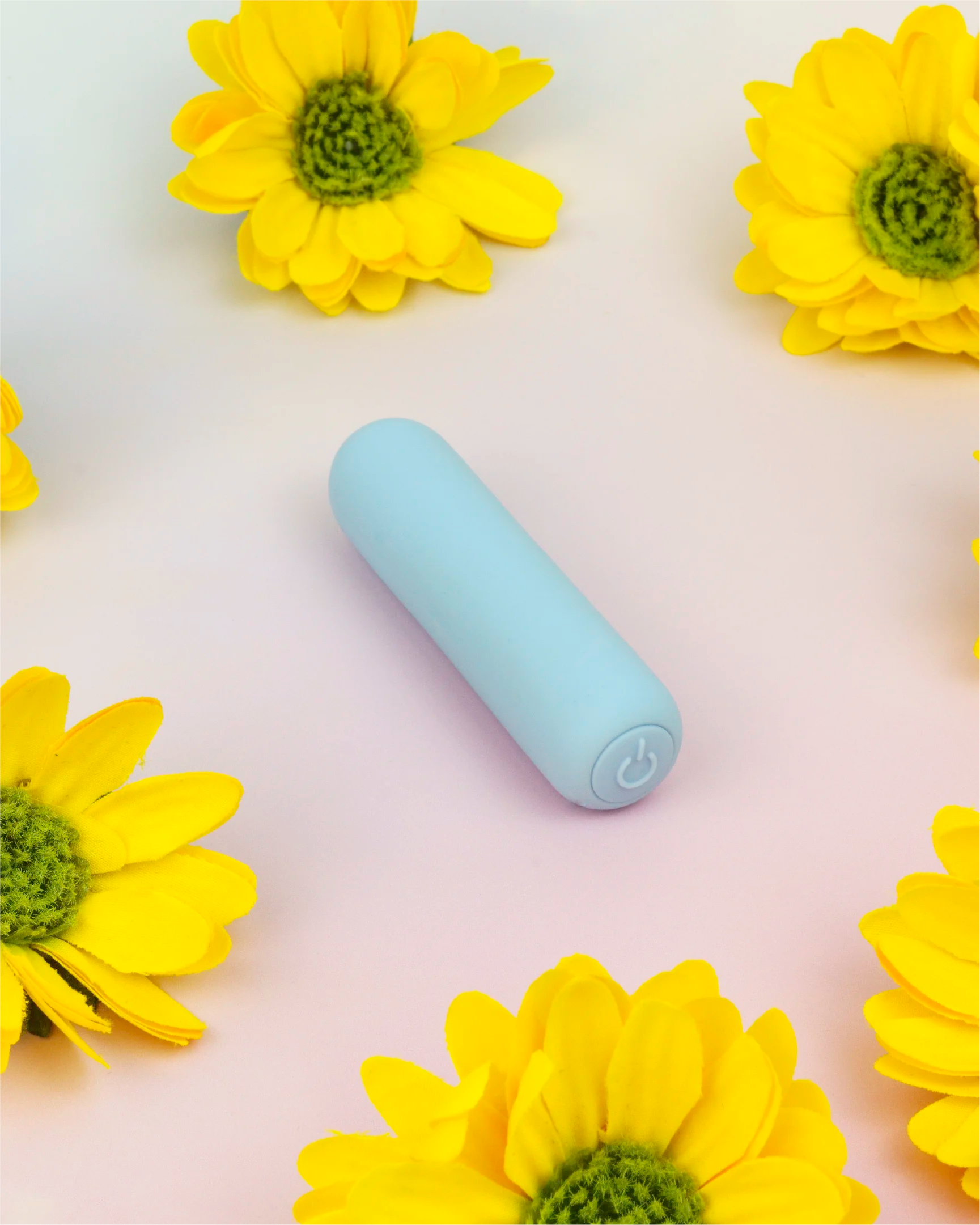 Pastel blue Joy Pippa compact bullet vibrator in clean flat lay with floral background, designed for targeted stimulation and comfort