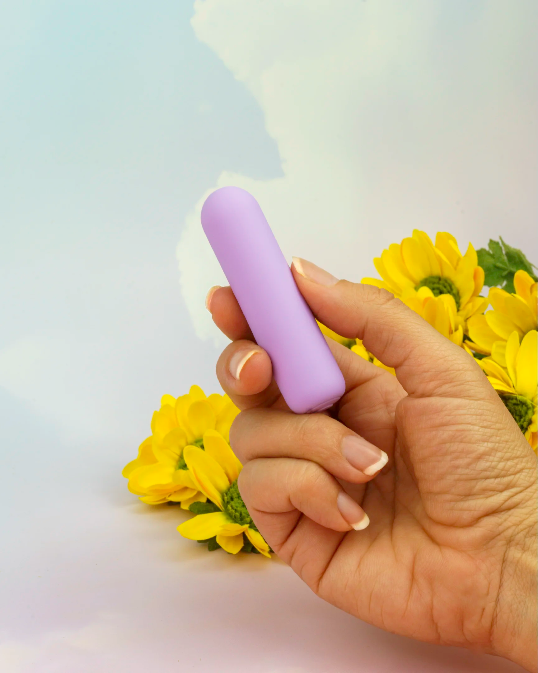 Pastel purple Joy Pippa mini bullet vibrator held in hand to show discreet size, travel-ready design with smooth silicone texture