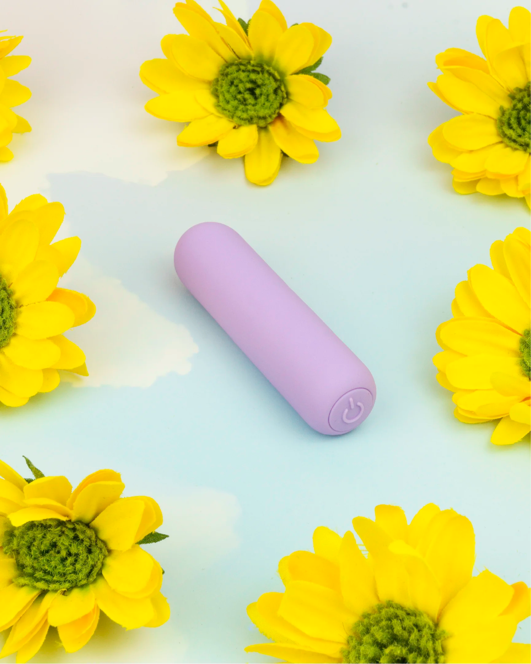 Pastel purple Joy Pippa compact bullet vibrator in minimal flat lay with floral accents, designed for precise stimulation and easy everyday use