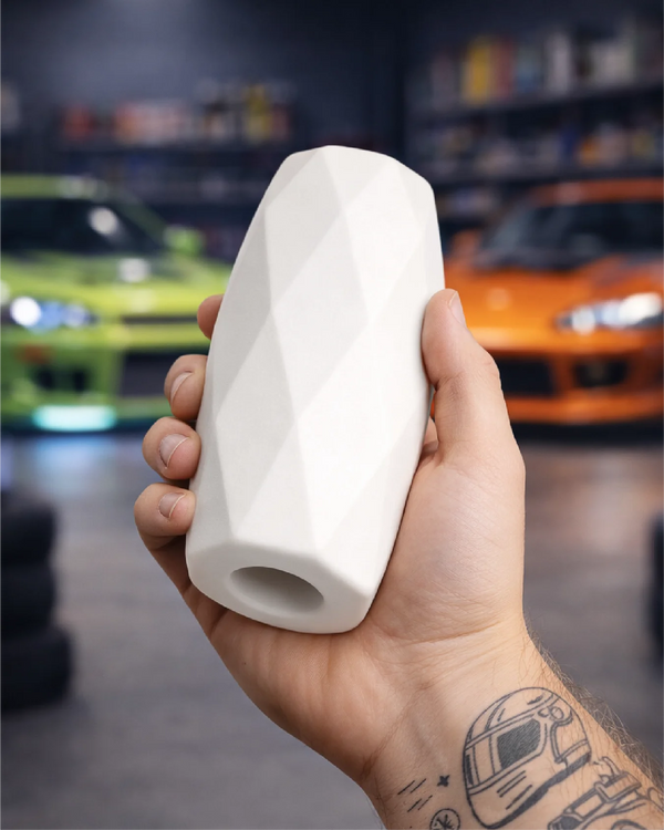 Nitrous Boost male stroker held in hand showing size scale and closed-ended sealed design